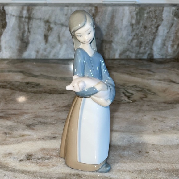Lladro porcelain figurine of girl holding a pig